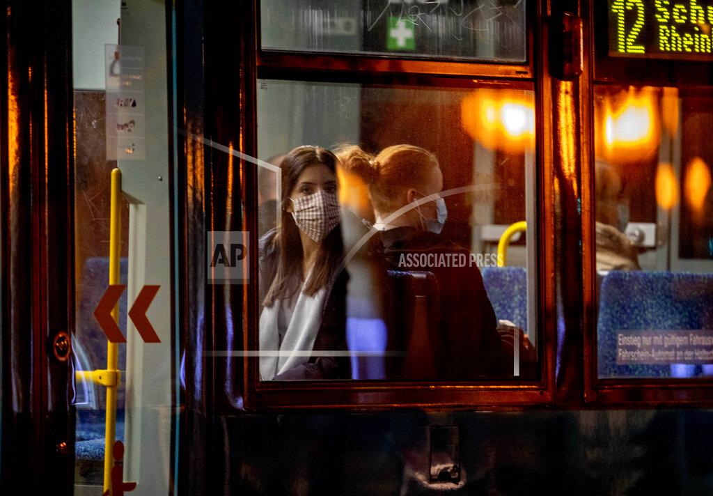 Michael Probst Two women wear face masks as the use a tram in Frankfurt, Germany, early Monday, Oct. 19, 2020. (AP Photo/Michael Probst)