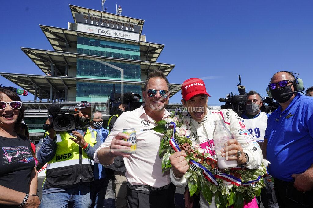 Darron Cummings Helio Castroneves, of Brazil, celebrates winning the Indianapolis 500 auto race at Indianapolis Motor Speedway with Mike Shank, Sunday, May 30, 2021, in Indianapolis. (AP Photo/Darron Cummings)