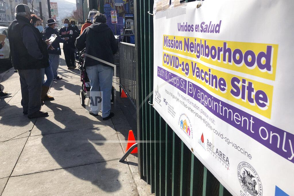 Haven Daley FILE - In this Feb. 8, 2021 file photo people wait in line at a COVID-19 vaccine site in the Mission district of San Francisco. San Francisco city workers will be required to be vaccinated against the coronavirus when a vaccine receives full federal approval. The policy covering 35,000 municipal workers may be the first by any city or county in the U.S., the San Francisco Chronicle reported Wednesday, June 23. (AP Photo/Haven Daley,File)