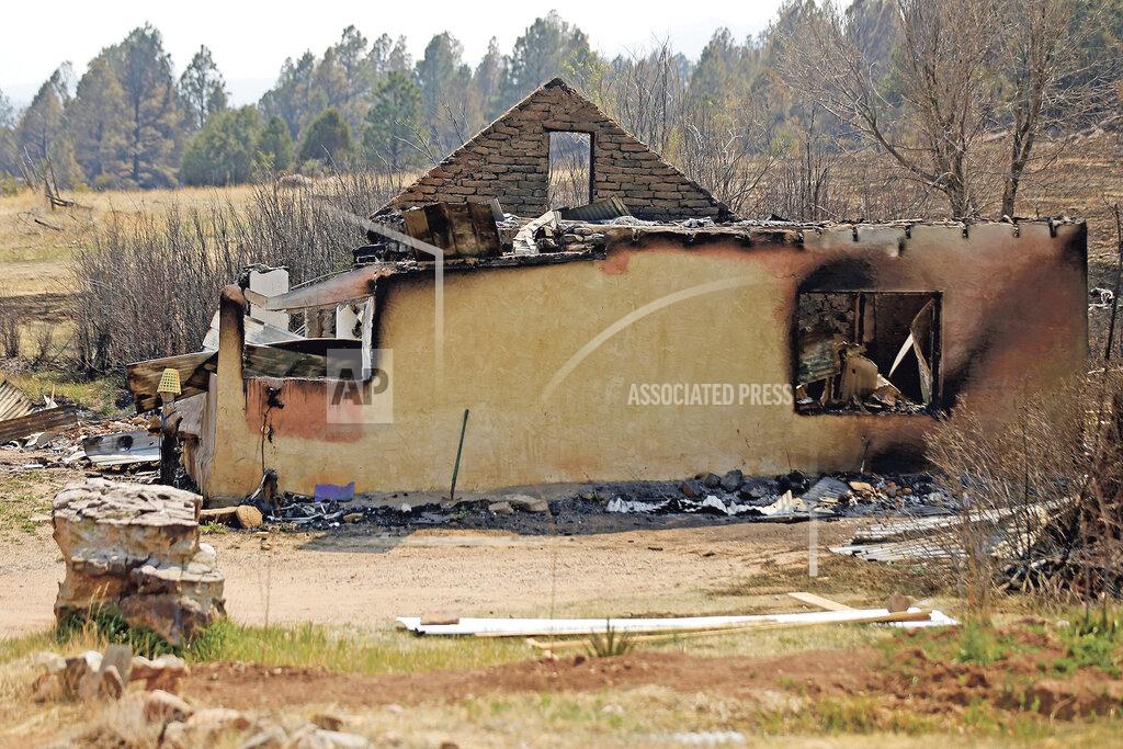 Luis Sanchez Saturno A burnt home following a wildfire is seen in Sapello, New Mexico, on Tuesday, May 10, 2022. The largest wildfire burning in the United States was heading toward mountain resort towns in northern New Mexico on Wednesday, prompting officials to issue another set of warnings for more people to prepare to evacuate as the fast-moving fire picks up momentum. (Luis Sanchez Saturno/The New Mexican via AP)