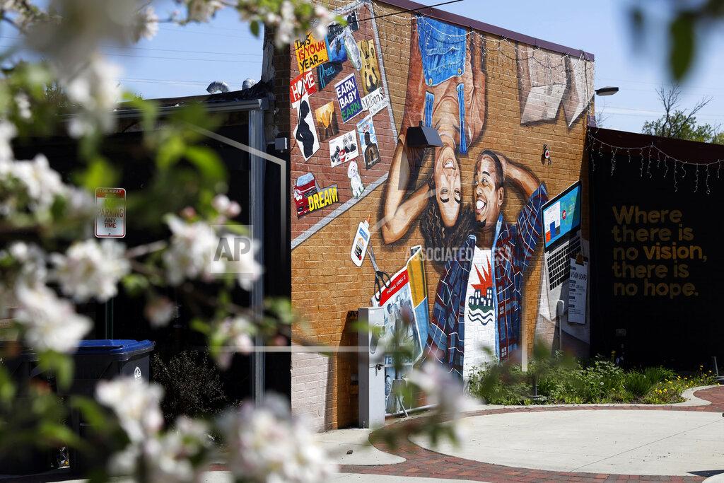 Shafkat Anowar This photo shows a mural painted on the outside wall of Gibbs-Morrison Cultural Center in the 5th Ward of Evanston, Ill., Thursday, April 29, 2021. The Chicago suburb is preparing to pay reparations in the form of housing grants to Black residents who experienced housing discrimination. (AP Photo/Shafkat Anowar)