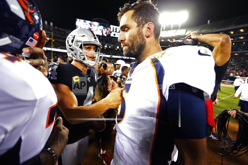 D. Ross Cameron Denver Broncos quarterback Joe Flacco, right, is met by Oakland Raiders quarterback Derek Carr at the end of an NFL football game Monday, Sept. 9, 2019, in Oakland, Calif. Oakland won the game 24-16. (AP Photo/D. Ross Cameron)