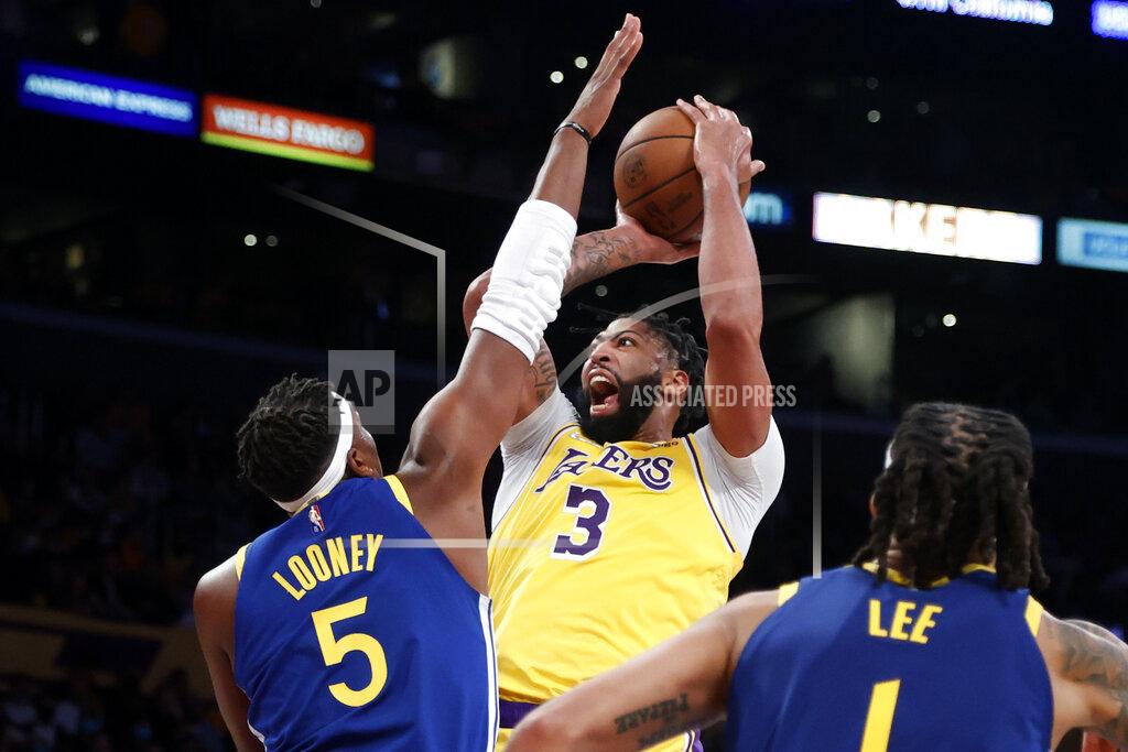 Ringo H.W. Chiu Los Angeles Lakers forward Anthony Davis (3) shoots against Golden State Warriors center Kevon Looney (5) during the first half of an NBA basketball game in Los Angeles, Tuesday, Oct. 19, 2021. (AP Photo/Ringo H.W. Chiu)