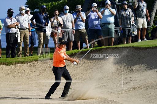 Kevin Na hits out of the 11th bunker during the first round of the Sony Open golf tournament, Thursday, Jan. 13, 2022, at Waialae Country Club in Honolulu. (AP Photo/Matt York)