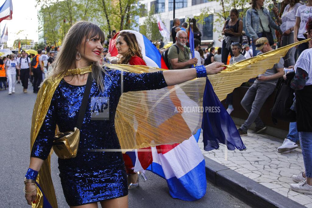 Olivier Matthys A woman dances as people gather near EU headquarters during a so called "European Demonstration for Freedom and Democracy" protest against COVID-19 security measures taken by European governments, in Brussels, Saturday, May 29, 2021. (AP Photo/Olivier Matthys)