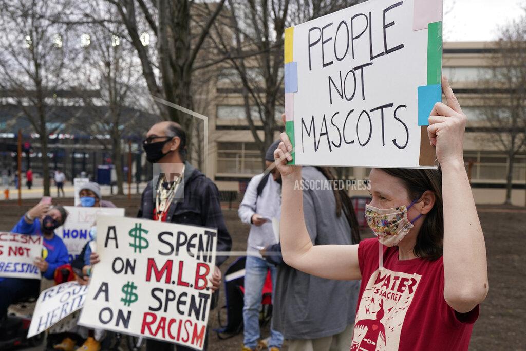 Tony Dejak Jolene Adkins, right, protests against racism before a baseball game between the Kansas City Royals and the Cleveland Indians, Monday, April 5, 2021, in Cleveland. (AP Photo/Tony Dejak)