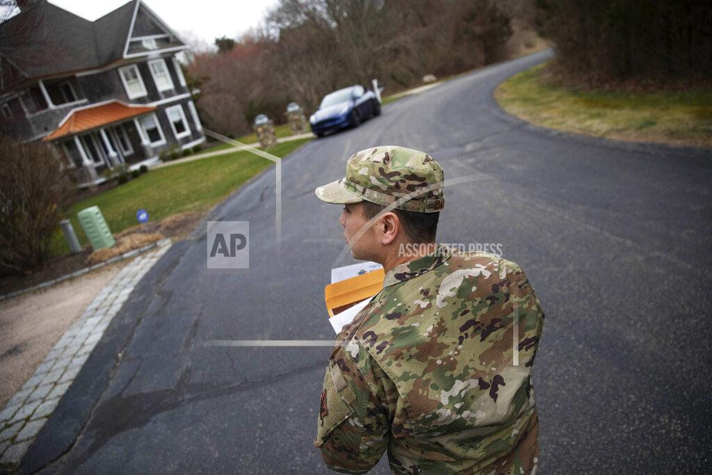 David Goldman FILE - In this March 28, 2020, file photo, Rhode Island Air National Guard Tsgt. William Randall walks through the Watch Hill neighborhood looking for New York residents to inform them of self quarantine orders in Westerly, R.I. The coronavirus pandemic was Rhode Island's top story of 2020. (AP Photo/David Goldman, File)