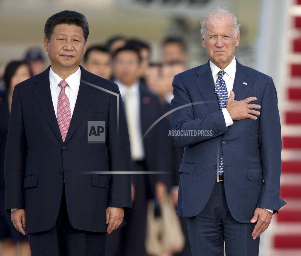 FILE - In this Sept. 24, 2015, file photo, Chinese President Xi Jinping, Vice President Joe Biden, stand for the U.S. national anthem during an arrival ceremony in Andrews Air Force Base, Md. (AP Photo/Carolyn Kaster, File)