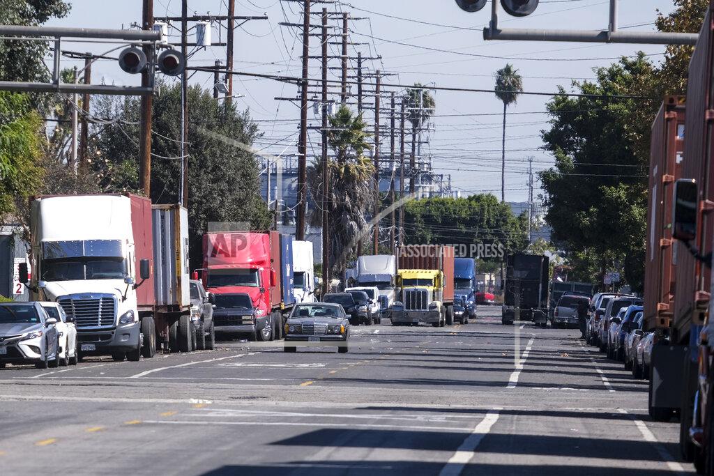 Ringo H.W. Chiu Parked cargo container trucks are seen in a street, Wednesday, Oct. 20, 2021 in Wilmington, Calif. California Gov. Gavin Newsom on Wednesday issued an order that aims to ease bottlenecks at the ports of Los Angeles and Long Beach that have spilled over into neighborhoods where cargo trucks are clogging residential streets. (AP Photo/Ringo H.W. Chiu)