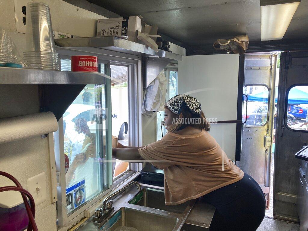 José Ignacio Castañeda Yolanda Parson is pictured inside of her food truck, Crab Cravers, at its grand opening in Wilmington, Delaware, on Sunday, July 18, 2021. (José Ignacio Castañeda /The News Journal via AP)