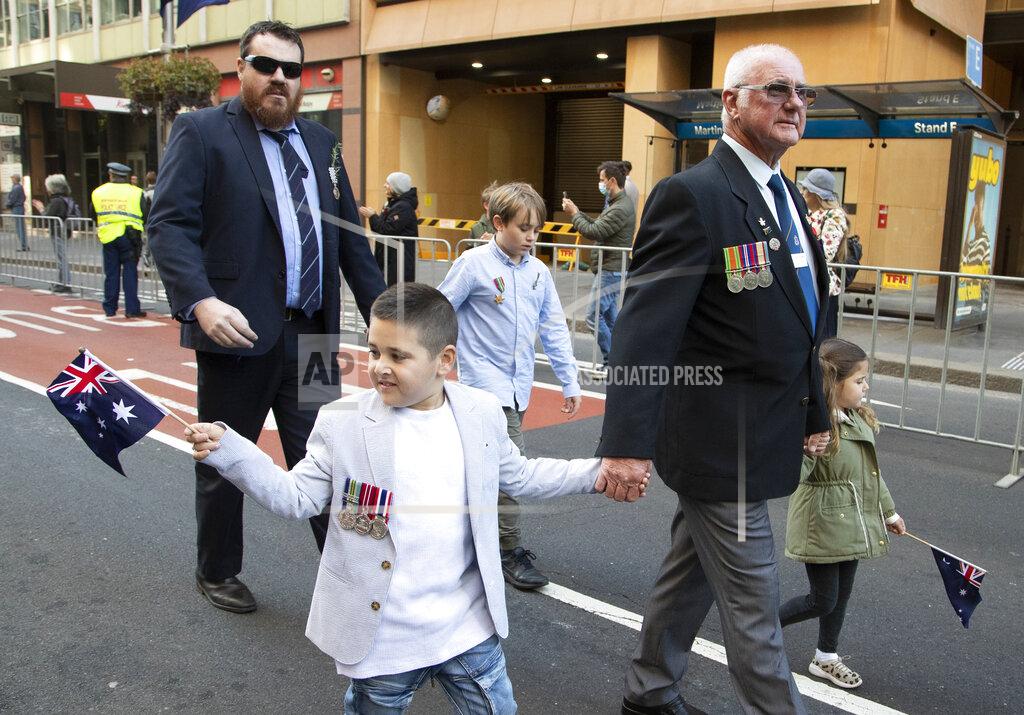 Mark Baker Veterans march during the Anzac Day parade in Sydney, Australia, Sunday, April 25, 2021. Australians and New Zealanders paid tribute to their war dead Sunday as both nations prepared to withdraw from their longest war in Afghanistan. (AP Photo/Mark Baker)
