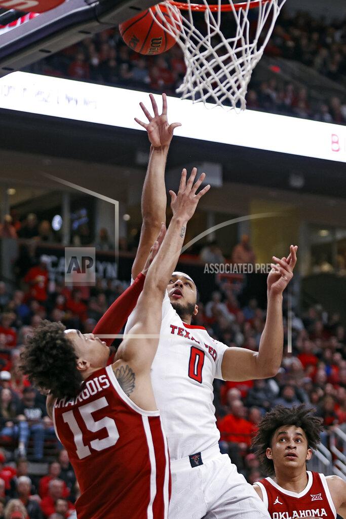 Brad Tollefson Texas Tech's Kevin Obanor (0) shoots over Oklahoma's Ethan Chargois (15) during the first half of an NCAA college basketball game Tuesday, Feb. 22, 2022, in Lubbock, Texas. (AP Photo/Brad Tollefson)