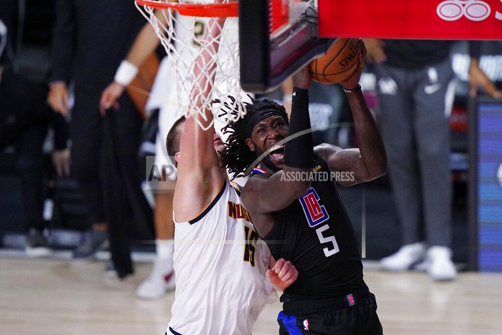 Mark J. Terrill Los Angeles Clippers forward Montrezl Harrell (5) drives to the basket Denver Nuggets center Nikola Jokic (15) during the second half of an NBA conference semifinal playoff basketball game Tuesday, Sept. 15, 2020, in Lake Buena Vista, Fla. (AP Photo/Mark J. Terrill)