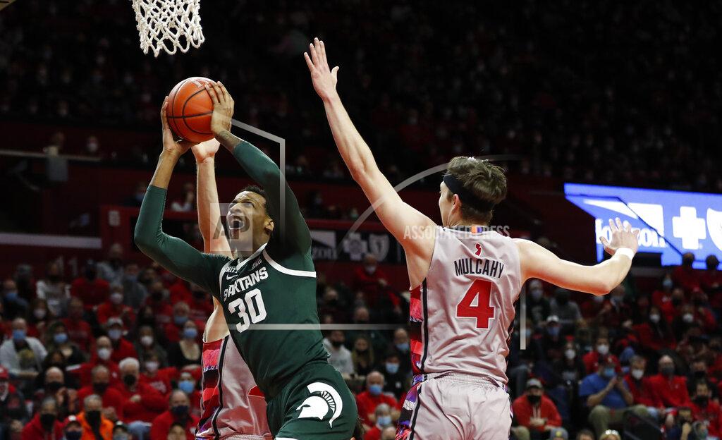 Noah K. Murray Michigan State forward Marcus Bingham Jr. (30) drives to the basket against Rutgers guard Paul Mulcahy (4) during the first half of an NCAA college basketball game in Piscataway, N.J., Saturday, Feb. 5, 2022. (AP Photo/Noah K. Murray)