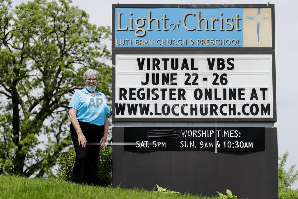 Nam Y. Huh Associate Pastor Sharon Rogers poses for a photo at Light of Christ Lutheran Church in Algonquin, Ill., Sunday, May 24, 2020. Rogers said 23 children – mostly 13-year-olds – are expected to be confirmed in their parking lot on June 13. Each family will be allowed to bring three vehicles, parking in every other space in deference to social distancing. (AP Photo/Nam Y. Huh)