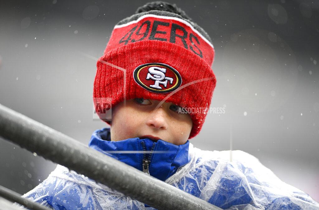 Nick Wass A young fans waits in the rain for players to take the field before the start of an NFL football game between the Baltimore Ravens and the San Francisco 49ers, Sunday, Dec. 1, 2019, in Baltimore, Md. (AP Photo/Nick Wass)