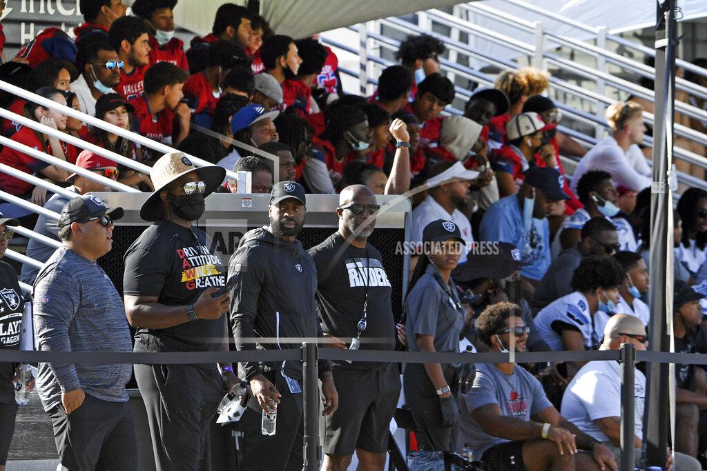 David Becker Las Vegas Raiders fans watch the team during an NFL football practice Saturday, July 31, 2021, in Henderson, Nev. (AP Photo/David Becker)