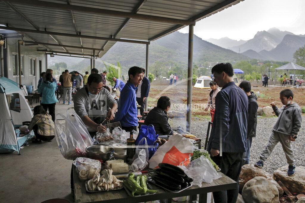 Andy Wong People gather for a barbecue at a scenic area in Fangshan district in Beijing, Monday, May 4, 2020, after authorities loosened up nationwide restrictions following months of lockdown over the new coronavirus outbreak. China reported three new coronavirus cases Monday, all brought from overseas, and no additional deaths. (AP Photo/Andy Wong)