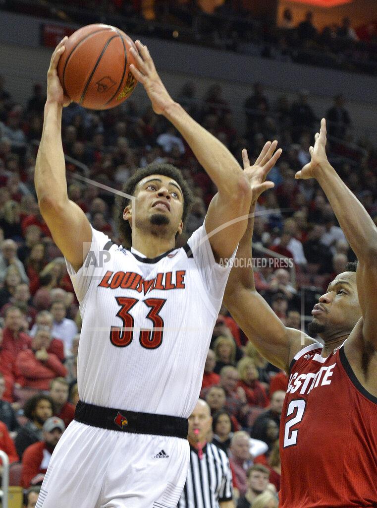 Timothy D. Easley Louisville forward Jordan Nwora (33) shoots next to North Carolina State guard Torin Dorn (2) during the second half of an NCAA college basketball game in Louisville, Ky., Thursday, Jan. 24, 2019. Louisville won 84-77. (AP Photo/Timothy D. Easley)