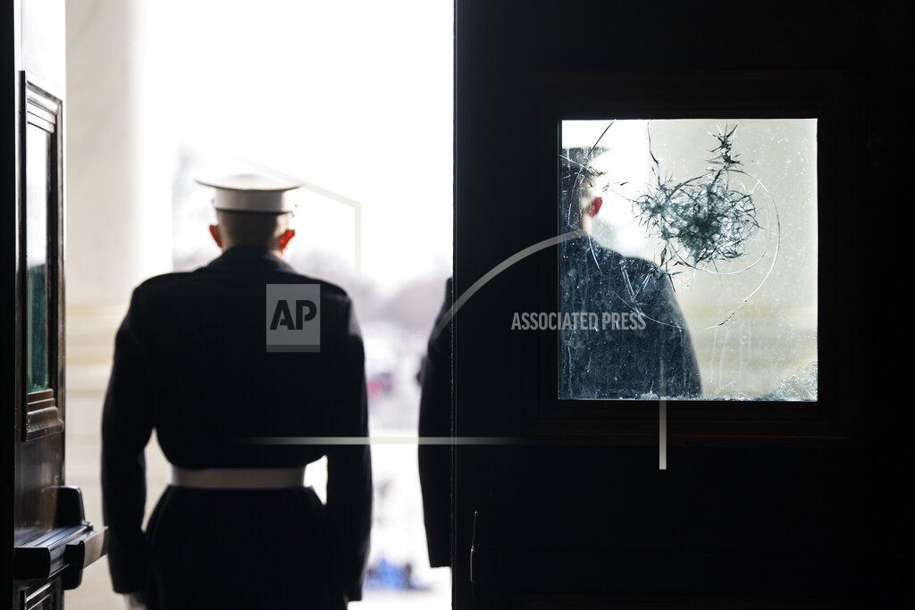 Jim Lo Scalzo U.S. Marine Corps. sentries outside a damaged door at the Capitol during a rehearsal for the 59th inaugural ceremony for President-elect Joe Biden and Vice President-elect Kamala Harris on Monday, January 18, 2021 at the U.S. Capitol in Washington. (Jim Lo Scalzo/Pool via AP)