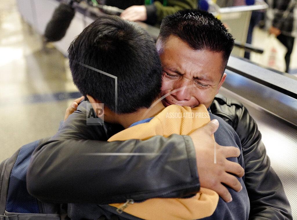 Ringo H.w. Chiu FILE - In this Jan. 22, 2020 file photo, David Xol-Cholom of Guatemala hugs his son, Byron, at Los Angeles International Airport as they reunite after being separated about one-and-half years ago during the Trump administration's wide-scale separation of immigrant families. On Friday, Feb. 5, 2021, The Associated Press reported on stories circulating online incorrectly asserting that nine parents who were deported under the Trump administration after being separated from their children at the border were allowed to return to the United States on Wednesday, Feb. 3, 2021. The family reunions referenced on social media did not happen this week, they occurred in 2020 due to a court order. (AP Photo/Ringo H.W. Chiu)