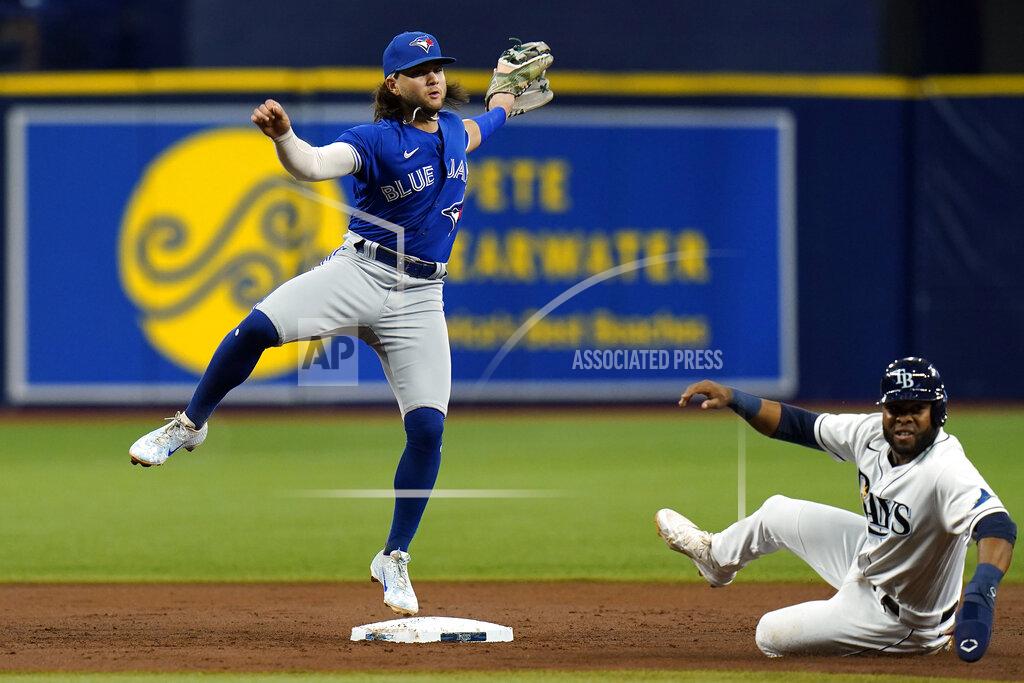 Chris O'MEara Toronto Blue Jays shortstop Bo Bichette forces Tampa Bay Rays' Manuel Margot, right, at second base and turns a double play on Kevin Kiermaier during the second inning of a baseball game Tuesday, Sept. 21, 2021, in St. Petersburg, Fla. (AP Photo/Chris O'Meara)