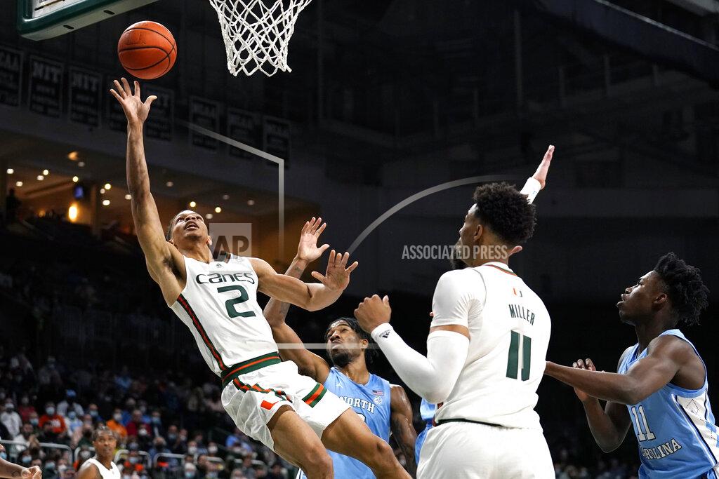 Lynne Sladky Miami guard Isaiah Wong (2) shoots over North Carolina guard Dontrez Styles, second from left, and guard D'Marco Dunn, right, during the second half of an NCAA college basketball game, Tuesday, Jan. 18, 2022, in Coral Gables, Fla. Miami won 85-57. (AP Photo/Lynne Sladky)