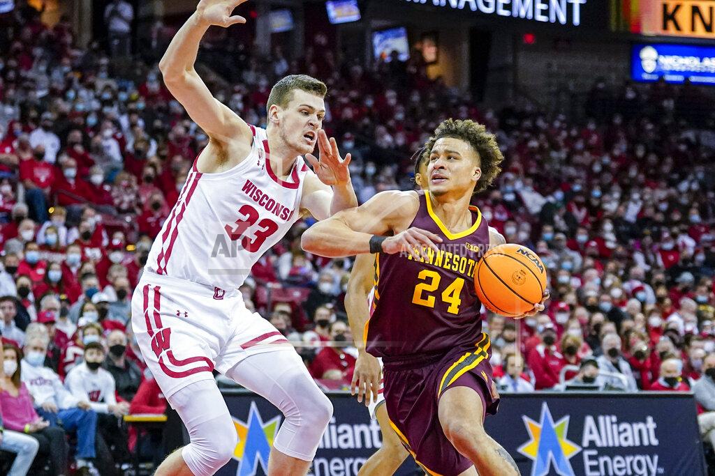 Andy Manis Minnesota's Sean Sutherlin (24) drives against Wisconsin's Chris Vogt (33) during the first half of an NCAA college basketball game Sunday, Jan. 30, 2022, in Madison, Wis. (AP Photo/Andy Manis)