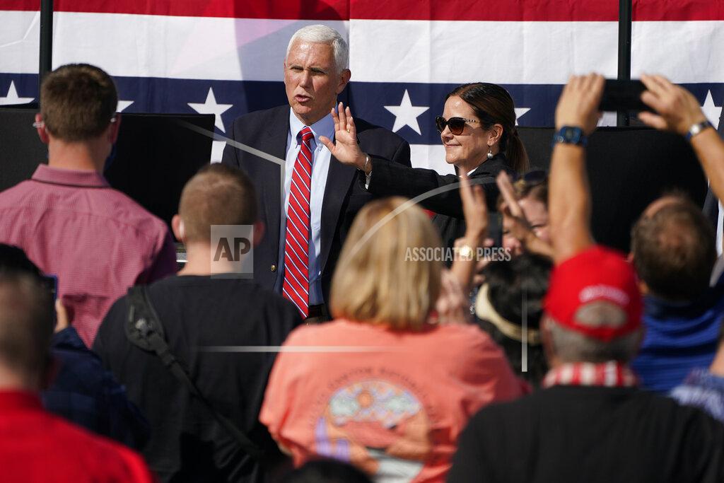 Vice President Mike Pence and second lady Karen Pence wave to the crowd from the rope line during a campaign event Thursday, Oct. 8, 2020, in Boulder City, Nev. (AP Photo/John Locher)