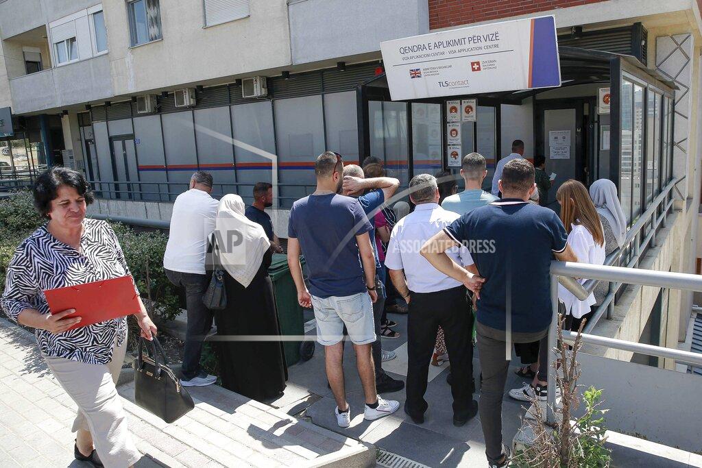 Visar Kryeziu Kosovars wait in line outside a visa application center in Kosovo's capital Pristina, Tuesday, June 28, 2022. The European Union’s delay in allowing visa-free travel for the people of Kosovo has spread dismay and resentment in the continent’s newest state, and one Pristina businessman has retaliated by hitting EU officials where it hurts — the stomach. (AP Photo/Visar Kryeziu)