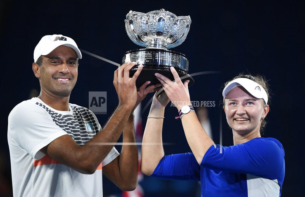 Andy Brownbill Rajeev Ram of the US and Barbora Krejcikova of the Czech Republic hold their trophy after defeating Australia's Samantha Stosur and Matthew Ebden in the mixed doubles final at the Australian Open tennis championship in Melbourne, Australia, Saturday, Feb. 20, 2021.(AP Photo/Andy Brownbill)