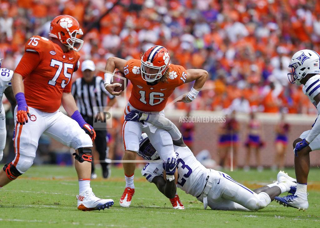 Richard Shiro Clemson quarterback Dillon Vann (16) is tackled by Furman's Elijah McKoy, while Mitch Hyatt (75) looks to block during the first half of an NCAA college football game Saturday, Sept. 1, 2018, in Clemson, S.C. (AP Photo/Richard Shiro)
