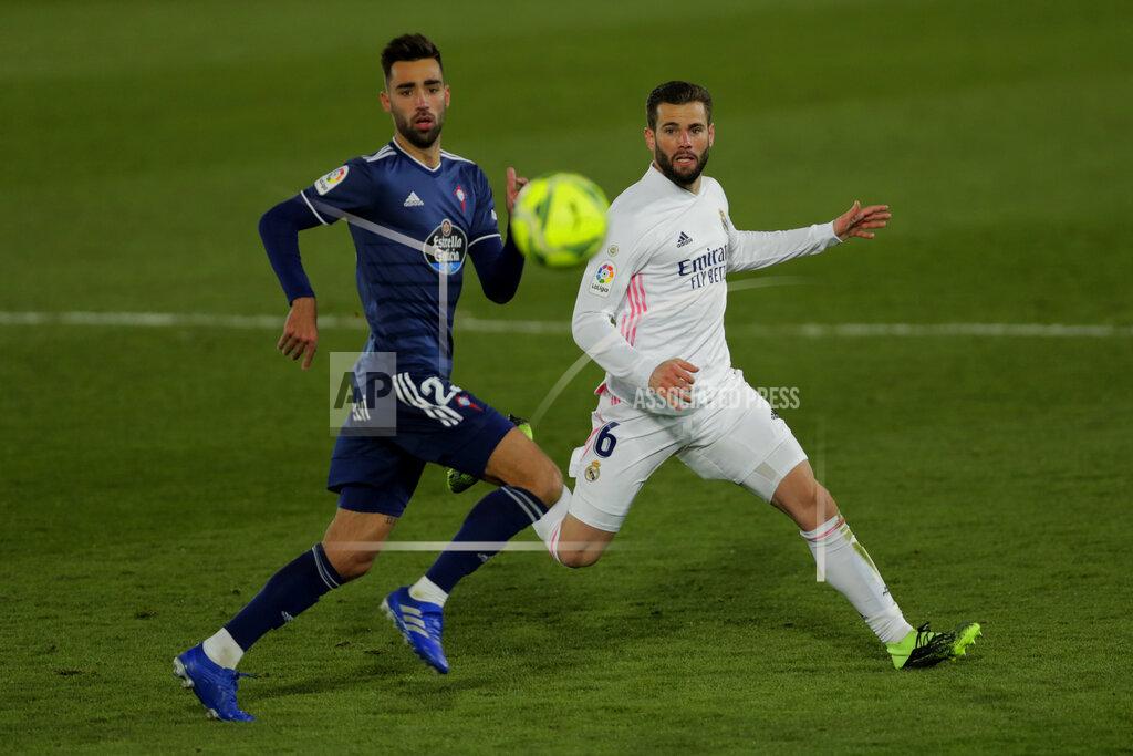 Manu Fernandez Real Madrid's Nacho, right, runs for the ball with Celta Vigo's Brais Mendez during the Spanish La Liga soccer match between Real Madrid and Celta Vigo at the Alfredo Di Stefano stadium in Madrid, Spain, Saturday, Jan. 2, 2021. (AP Photo/Manu Fernandez)