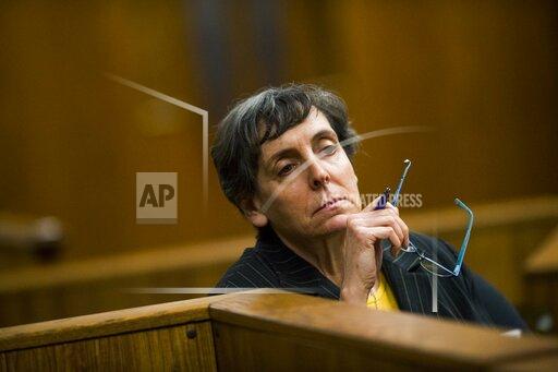 FILE- Defendant Liane Shekter Smith listens during a preliminary examination in the cases of four defendants, all former or current officials from the Michigan Department of Environmental Quality, in Flint, Mich on Feb. 5, 2018. The state of Michigan said Friday, Nov. 5, 2021, it agreed to pay $300,000 to the only employee who was fired as a result of lead-contaminated water in Flint. The agreement with Liane Shekter Smith, who was head of the state’s drinking water division, came weeks after an arbitrator said she was wrongly fired in 2016 by officials who were likely looking for a “public scapegoat” in one of the worst environmental disasters in U.S. history. (Jake May/The Flint Journal via AP, File)