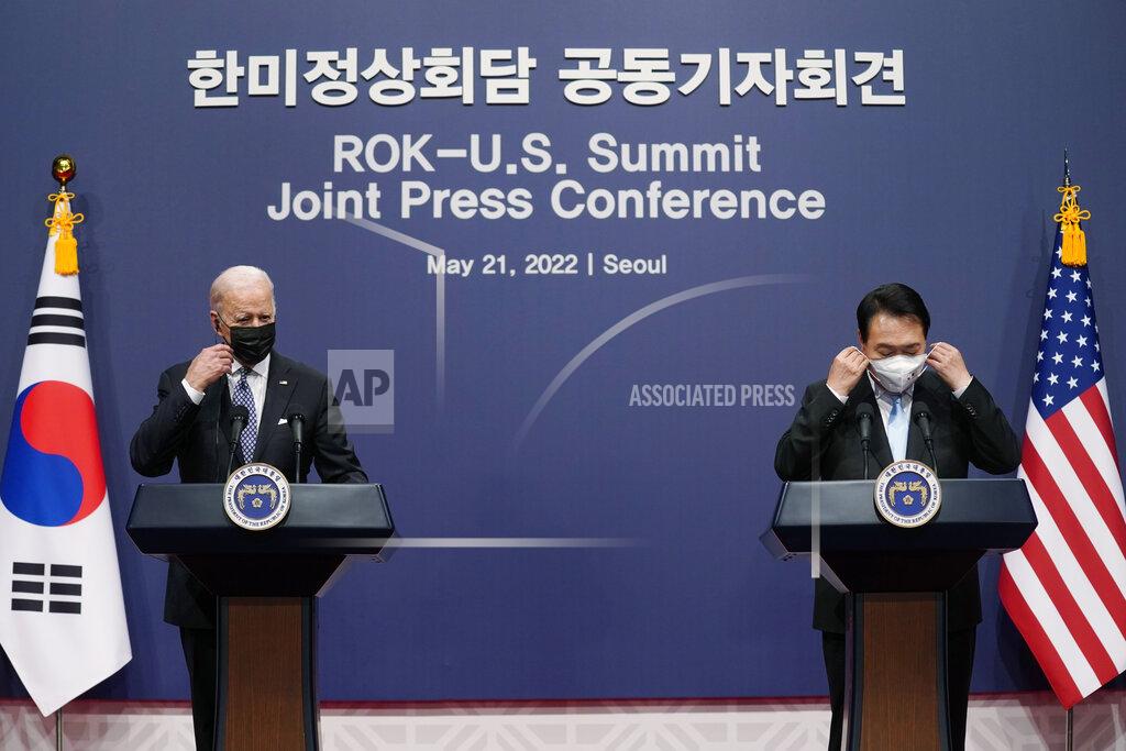 Evan Vucci U.S. President Joe Biden, left, and South Korean President Yoon Suk Yeol put their face masks back on at the end of a news conference at the People's House inside the Ministry of National Defense, Saturday, May 21, 2022, in Seoul, South Korea. (AP Photo/Evan Vucci)