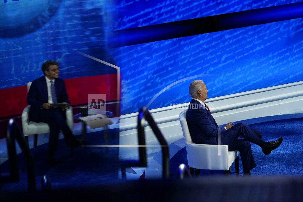 Democratic presidential candidate former Vice President Joe Biden participates in a town hall with moderator ABC News anchor George Stephanopoulos, seen reflected at left, at the National Constitution Center in Philadelphia, Thursday, Oct. 15, 2020. (AP Photo/Carolyn Kaster)