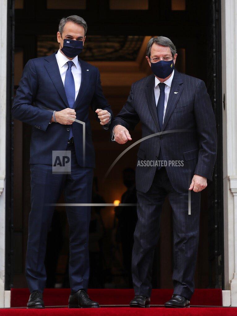 Petros Giannakouris Greece's Prime Minister Kyriakos Mitsotakis, left, welcomes Cypriot President Nicos Anastasiades at Maximos Mansion in Athens, Wednesday, March 24, 2021. The military parade on March 25, marking 200-years since the war that resulted in Greece's independence from the Ottoman Empire and rebirth as a nation, will be held without spectators due to the coronavirus, and only Greek and foreigners political officials. (AP Photo/Petros Giannakouris)