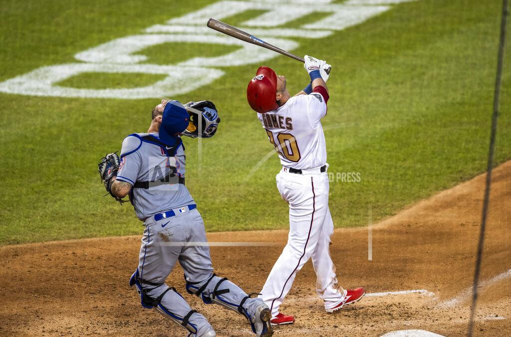 Manuel Balce Ceneta Washington Nationals Yan Gomes (10) and New York Mets catcher Tomás Nido (3) follow the ball as Gomes hit a foul ball during the third inning of a baseball game in Washington, Tuesday, Aug. 4, 2020. Nido missed the catch. (AP Photo/Manuel Balce Ceneta)