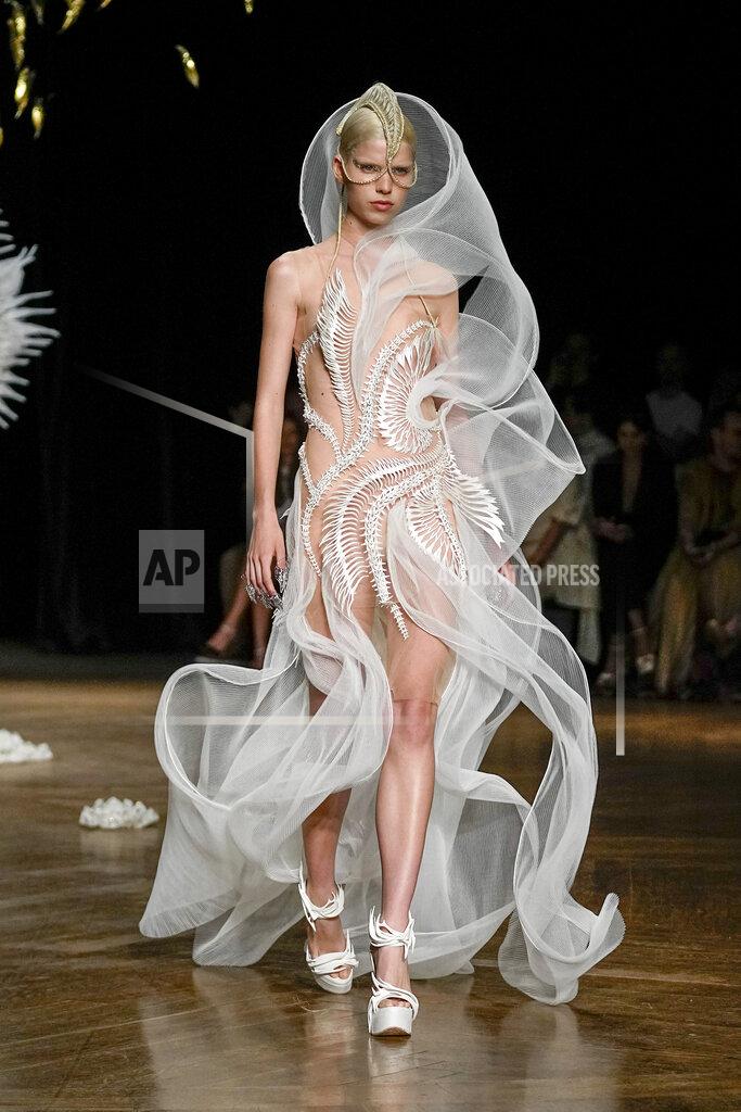Michel Euler A model wears a creation as part of Iris van Herpen Haute Couture Fall/Winter 2022-2023 fashion collection presented Monday, July 4, 2022 in Paris. (AP Photo/Michel Euler)
