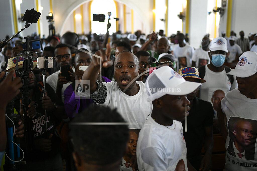 Matias Delacroix A man yells for justice during a memorial service for assassinated Haitian President Jovenel Moïse in the Cathedral of Cap-Haitien, Haiti, Thursday, July 22, 2021. Moïse was killed in his home on July 7. (AP Photo/Matias Delacroix)