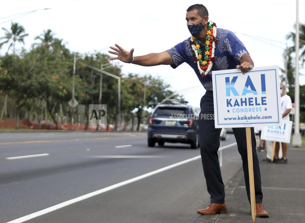 Kelsey Walling U.S. House of Representatives candidate Kai Kahele waves at people passing by while campaigning with supporters in Hilo, Hawaii, on Wednesday, Oct. 28, 2020. (Kelsey Walling/Hawaii Tribune-Herald via AP)
