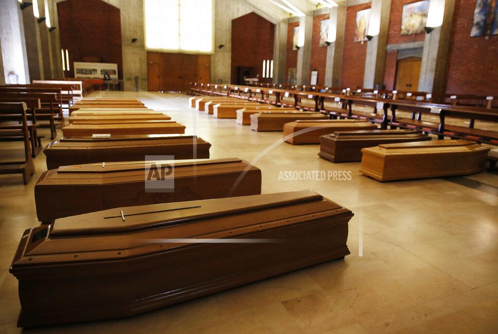 Antonio Calanni FILE - In this March 26, 2020 file photo, coffins are lined up on the floor in the San Giuseppe church in Seriate, one of the areas worst hit by coronavirus, near Bergamo, Italy, waiting to be taken to a crematorium. Italy is poised to reclaim the dishonor of reporting the most coronavirus deaths in Europe, as the second surge ravages the country’s disproportionately old population and exposes how public health shortfalls and delayed restrictions compounded a lack of preparedness going into the pandemic. (AP Photo/Antonio Calanni, file)
