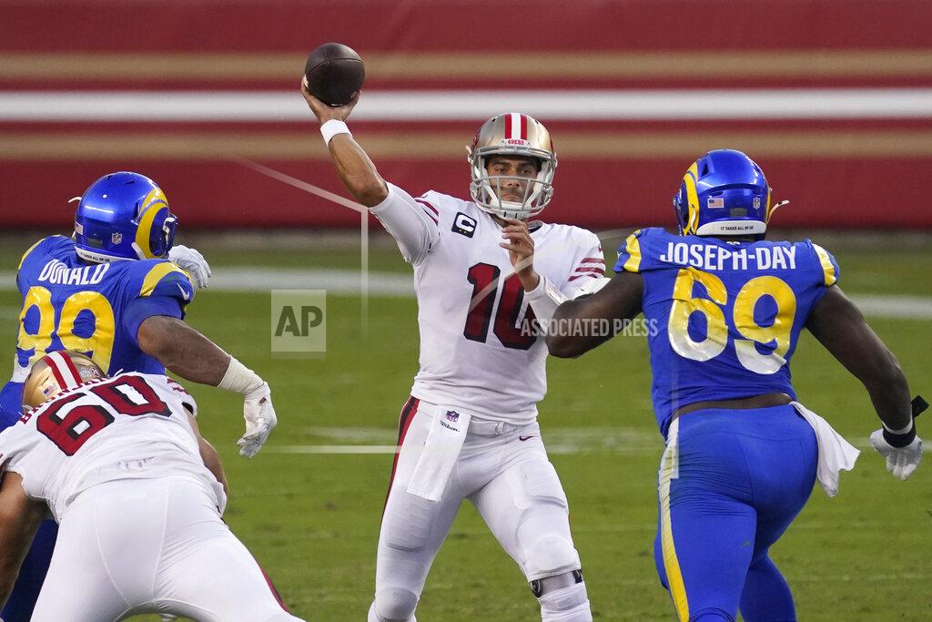 Tony Avelar San Francisco 49ers quarterback Jimmy Garoppolo (10) passes between Los Angeles Rams defensive end Aaron Donald (99) and nose tackle Sebastian Joseph-Day (69) during the first half of an NFL football game in Santa Clara, Calif., Sunday, Oct. 18, 2020. (AP Photo/Tony Avelar)