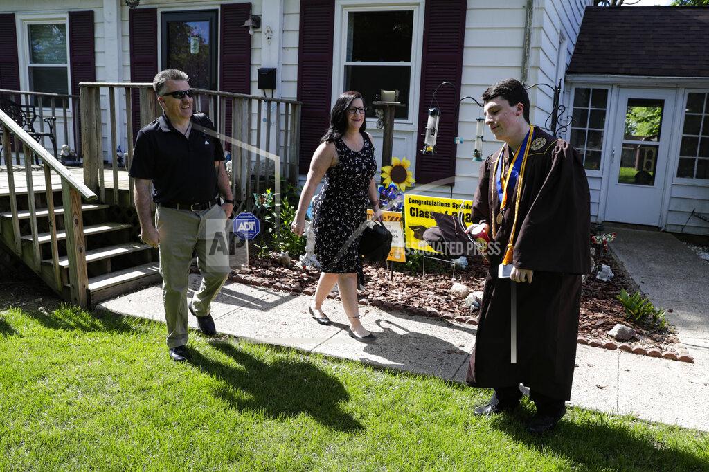Michael Conroy Jacob Foxworthy, right, and his parents Ted and Cindy Foxworthy leave their home to attend the Speedway High School graduation ceremony at the Indianapolis Motor Speedway in Indianapolis, Saturday, May 30, 2020. The ceremony was held at the track to allow for social distancing requirements due to the COVID-19 pandemic. When Ted Foxworthy was diagnosed with cancer, he set two goals: Celebrating his youngest child's 18th birthday and seeing him graduate. (AP Photo/Michael Conroy)