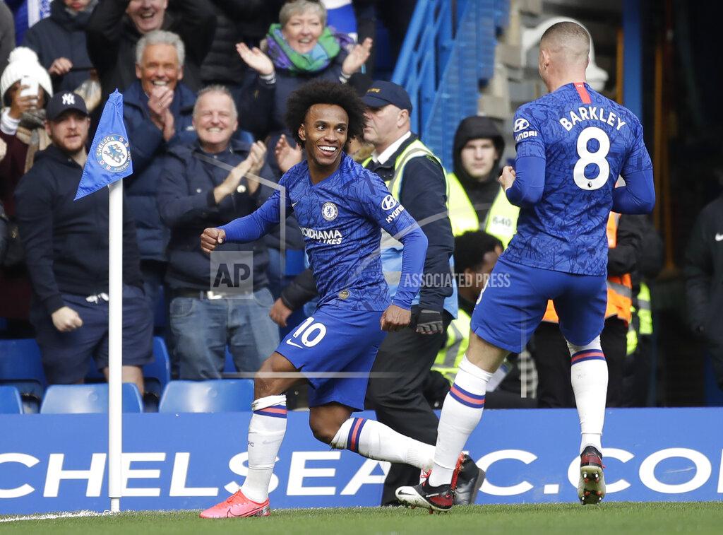 Chelsea's Willian, left, celebrates with Ross Barkley after scoring his side's third goal during the English Premier League soccer match between Chelsea and Everton at Stamford Bridge stadium in London, England, Sunday, March 8, 2020. (AP Photo/Matt Dunham)