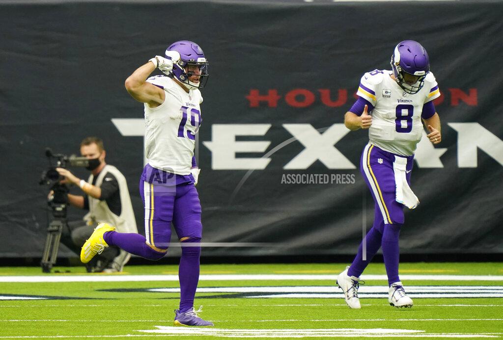 David J. Phillip Minnesota Vikings wide receiver Adam Thielen (19) and quarterback Kirk Cousins (8) celebrates after they connected on a pass for a touchdown against the Houston Texans during the second half of an NFL football game Sunday, Oct. 4, 2020, in Houston. (AP Photo/David J. Phillip)