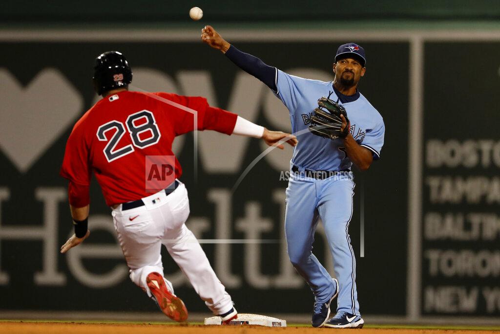 Winslow Townson Toronto Blue Jays' Marcus Semien throws over Boston Red Sox's J.D. Martinez but can't get a double play on a ball hit by Xander Bogaerts during the fifth inning of a baseball game Tuesday, April 20, 2021, at Fenway Park in Boston. (AP Photo/Winslow Townson)
