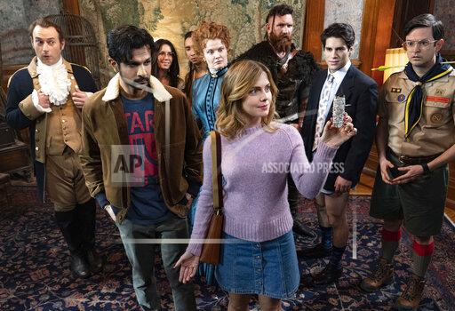 This image released by CBS shows Utkarsh Ambudkar, foreground left, and Rose McIver in a scene from the comedy series "Ghosts." (Cliff Lipson/CBS via AP)