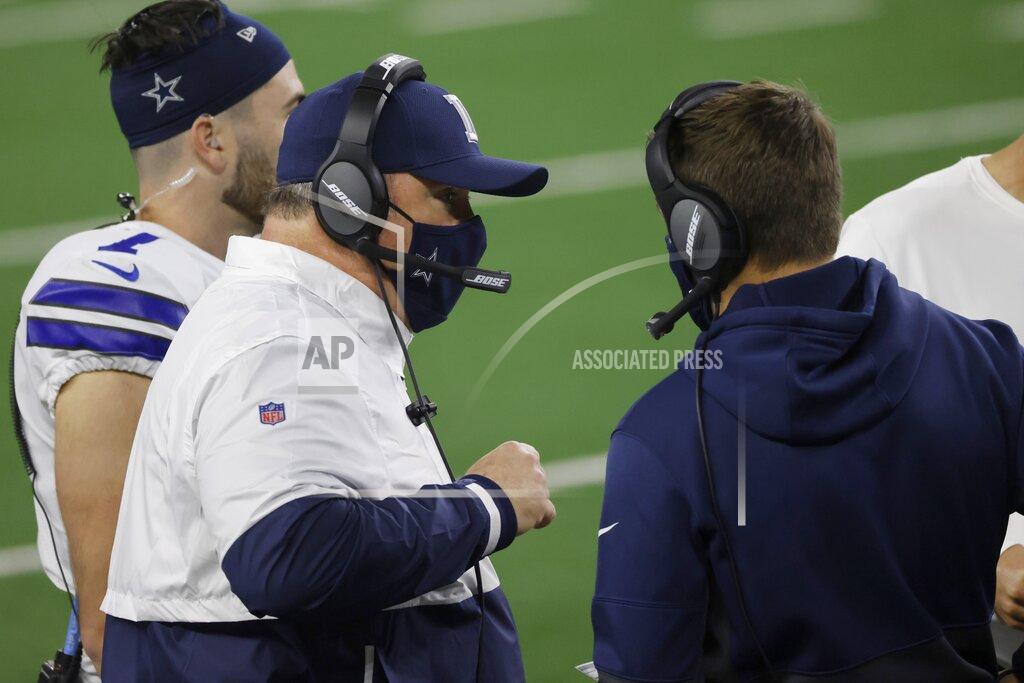 Ron Jenkins Dallas Cowboys head coach Mike McCarthy, left, talks with staff members in the second half of an NFL football game against the Arizona Cardinals in Arlington, Texas, Monday, Oct. 19, 2020. (AP Photo/Ron Jenkins)
