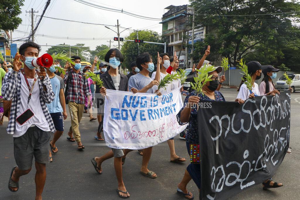 Uncredited Anti-coup protesters flash the three-finger salute, holding a banner during a demonstration against the military coup in Yangon, Myanmar, Monday, April 26, 2021. Southeast Asian leaders have demanded an immediate end to killings and the release of political detainees in Myanmar during an emergency summit in Jakarta with its top general and coup leader. (AP Photo)